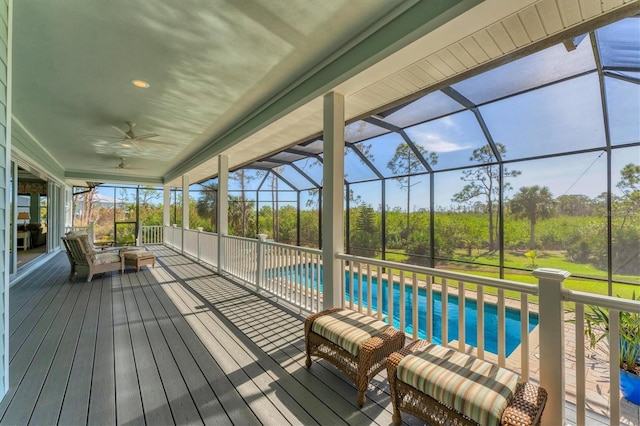 wooden terrace featuring a patio, ceiling fan, and glass enclosure