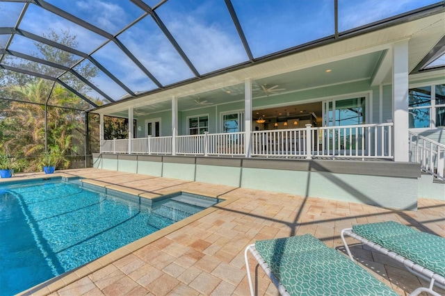 view of pool with a patio area, ceiling fan, and glass enclosure