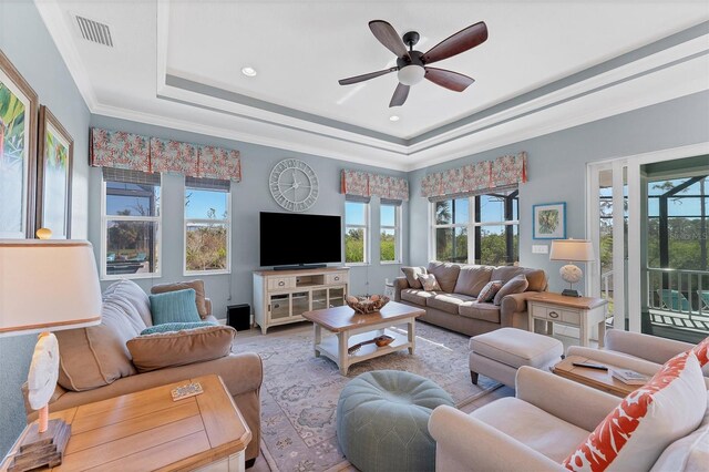 8025 Weyers Ct, Englewood, FL 34224 - living area with a tray ceiling, healthy amount of natural light, ceiling fan, ornamental molding, and wood finished floors