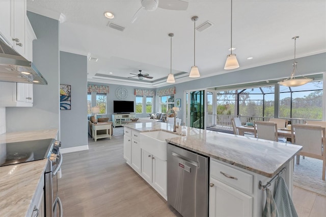 kitchen featuring appliances with stainless steel finishes, hanging light fixtures, light stone counters, sink, and white cabinetry