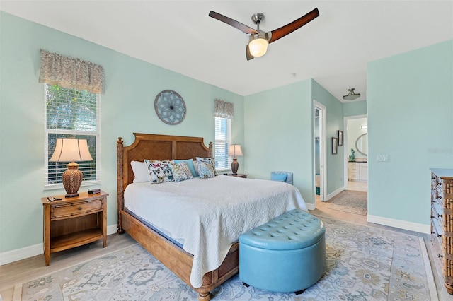 bedroom with ceiling fan, light hardwood / wood-style floors, and ensuite bathroom