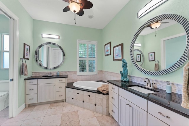 bathroom with tile patterned floors, ceiling fan, vanity, and toilet