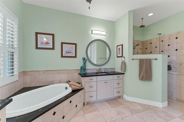 bathroom with shower with separate bathtub, tile patterned floors, and vanity