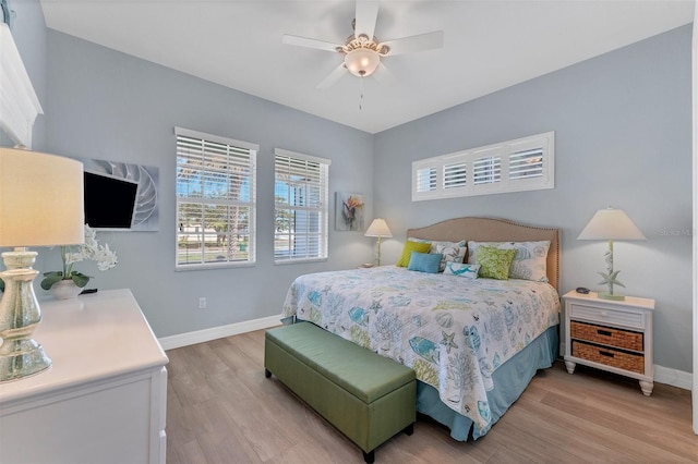 bedroom with ceiling fan and light hardwood / wood-style flooring