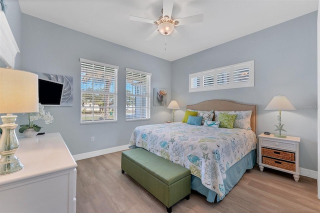 8025 Weyers Ct, Englewood, FL 34224 - bedroom with baseboards, light wood-style flooring, and a ceiling fan