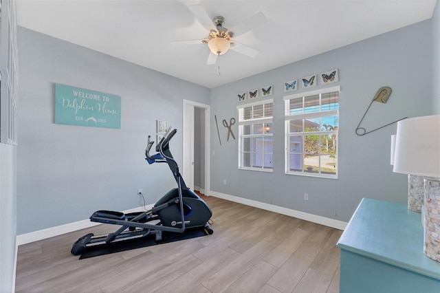 workout room with light wood-type flooring and ceiling fan