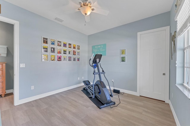 workout area featuring ceiling fan and light wood-type flooring