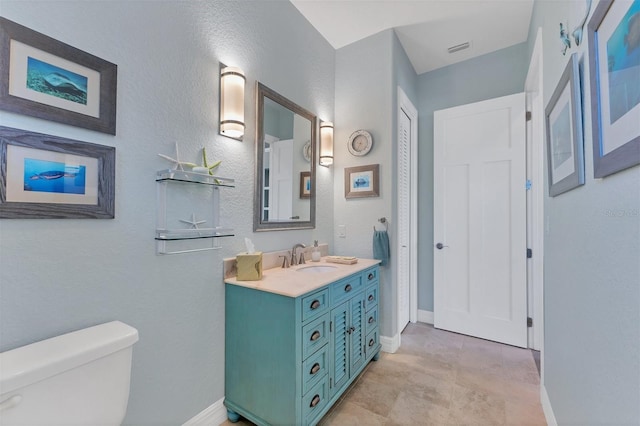 bathroom featuring vanity and toilet