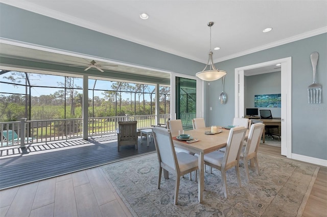 dining room with ceiling fan, ornamental molding, and wood-type flooring