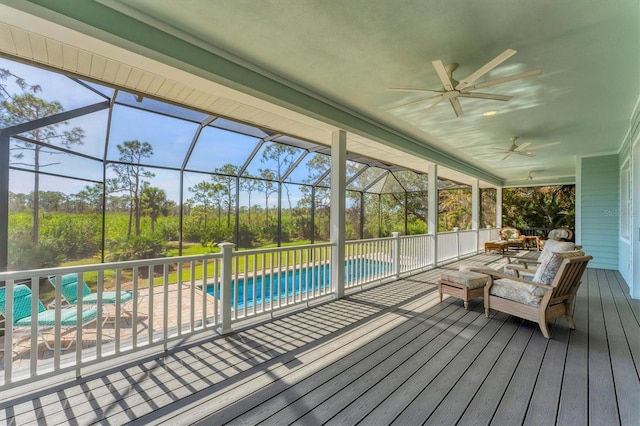 unfurnished sunroom with ceiling fan