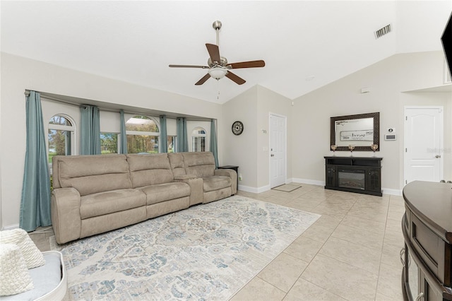 tiled living room featuring ceiling fan and vaulted ceiling