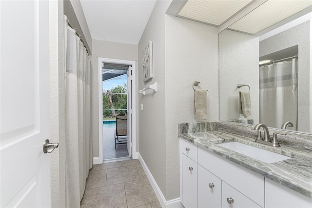 bathroom featuring tile patterned flooring, a textured ceiling, and vanity