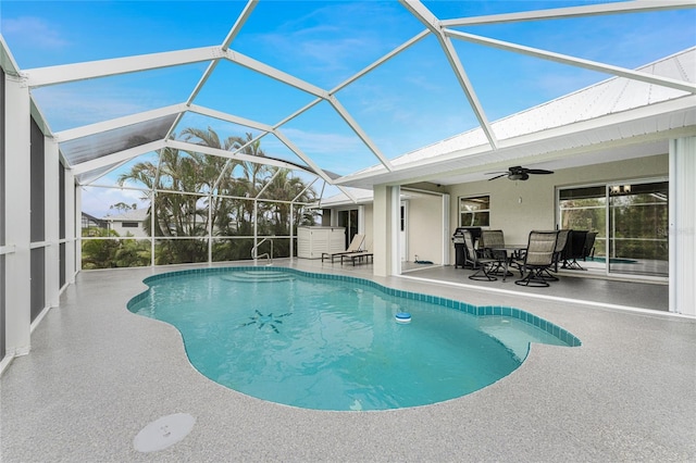 view of swimming pool featuring ceiling fan, a lanai, and a patio