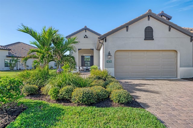 mediterranean / spanish-style home featuring a garage