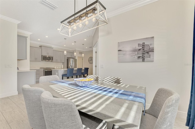 dining room with crown molding and light tile patterned floors