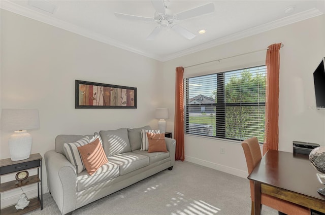 carpeted living room with ceiling fan and ornamental molding