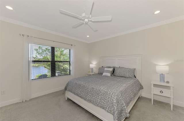 carpeted bedroom featuring ceiling fan and crown molding