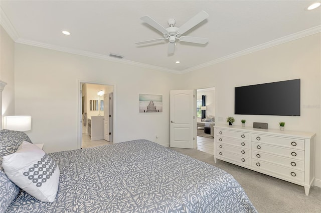 bedroom featuring ceiling fan, ornamental molding, light carpet, and ensuite bath