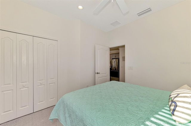 carpeted bedroom with stainless steel refrigerator with ice dispenser, a closet, and ceiling fan