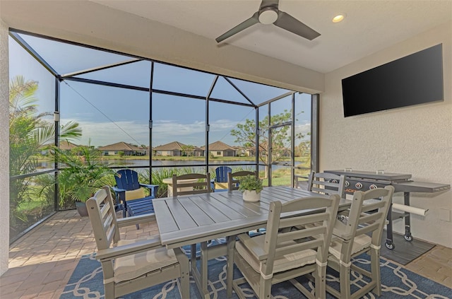 view of patio / terrace featuring ceiling fan and a lanai