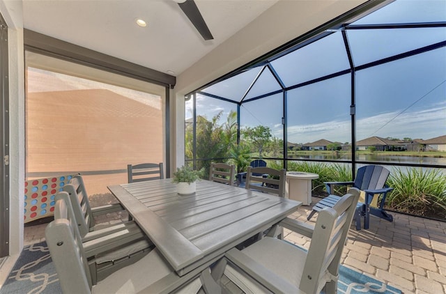 sunroom / solarium featuring a water view