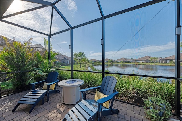 sunroom featuring a water view