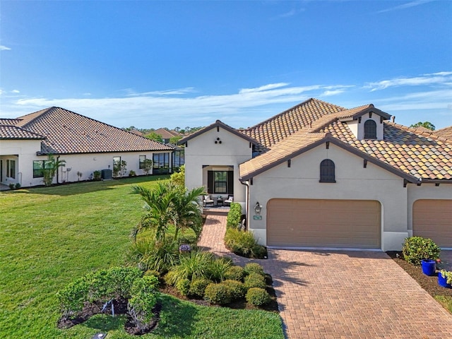 mediterranean / spanish-style house featuring a front yard and a garage