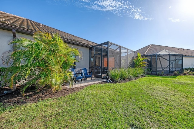 view of yard with a patio and glass enclosure