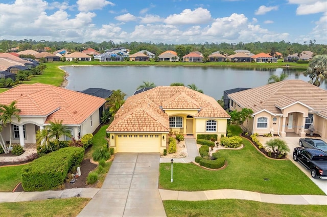 view of front of house with a front lawn, a water view, and a garage