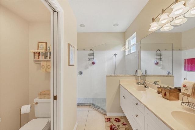 bathroom with a shower, vanity, tile patterned flooring, and toilet