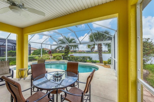 exterior space featuring a patio, a water view, glass enclosure, and ceiling fan