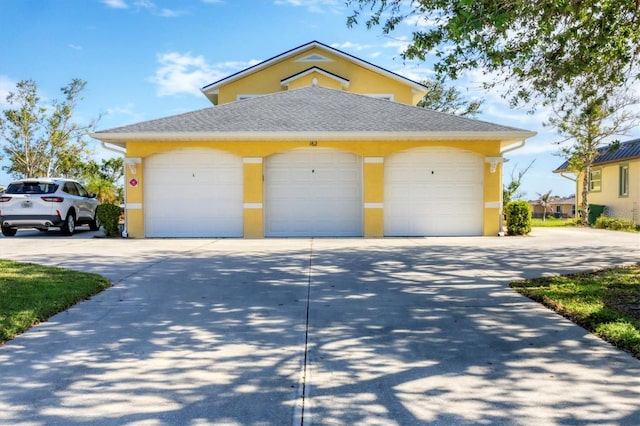 view of front of property featuring a garage and an outdoor structure