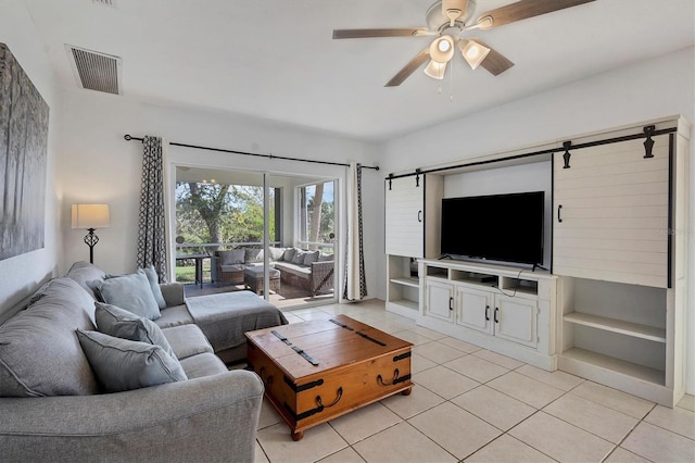 living room with light tile patterned floors and ceiling fan