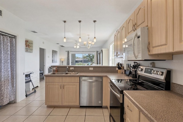 kitchen with hanging light fixtures, sink, light brown cabinetry, light tile patterned flooring, and stainless steel appliances