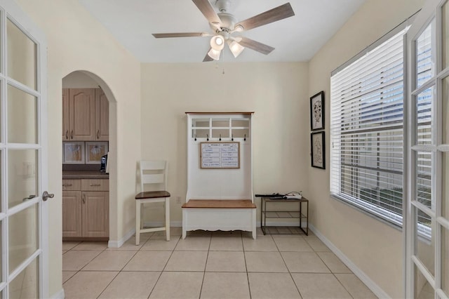 interior space featuring light tile patterned floors and ceiling fan