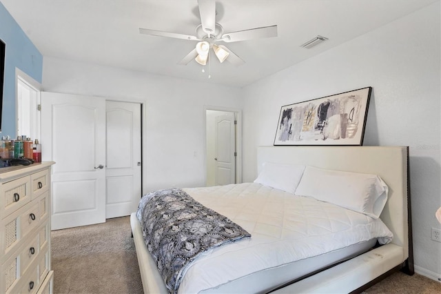 bedroom with a closet, dark carpet, and ceiling fan