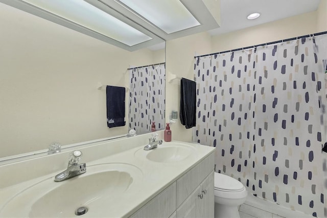 bathroom featuring tile patterned flooring, vanity, toilet, and curtained shower