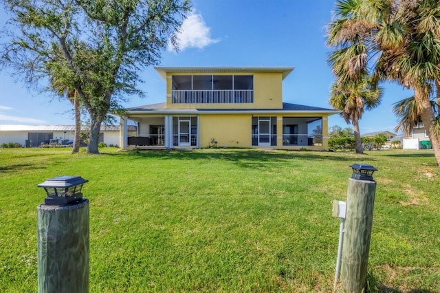 rear view of property with a lawn