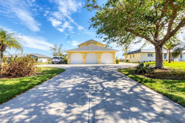 single story home with a front yard and a garage