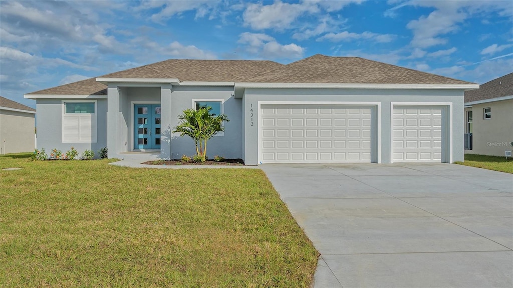 14304 Amestoy Ave, Port Charlotte, FL 33981 - view of front of property with an attached garage, driveway, a front yard, stucco siding, and roof with shingles
