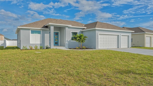 view of front of home with a front yard and a garage