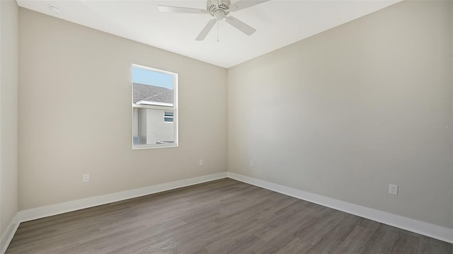 spare room with ceiling fan and wood-type flooring