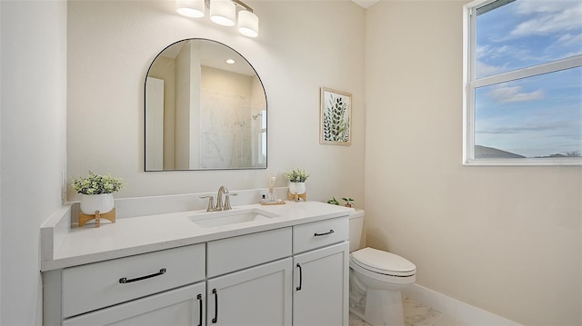 bathroom featuring vanity, toilet, and a shower