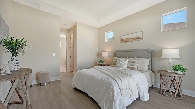 bedroom featuring light wood-type flooring and multiple windows