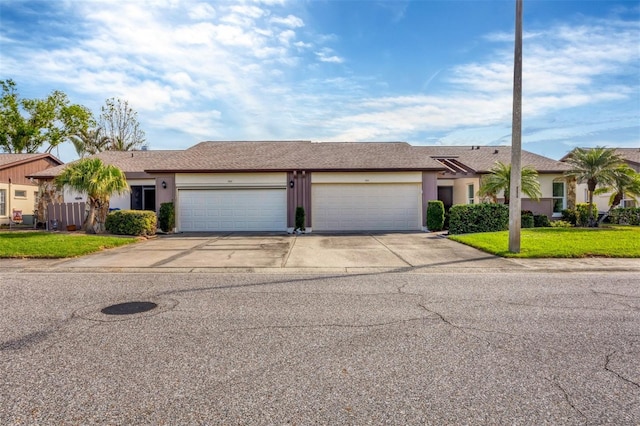 ranch-style home featuring a garage and a front lawn