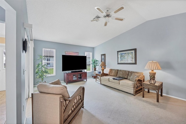 carpeted living room featuring ceiling fan and lofted ceiling