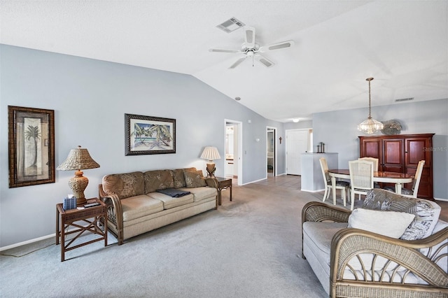 carpeted living room featuring ceiling fan with notable chandelier and lofted ceiling