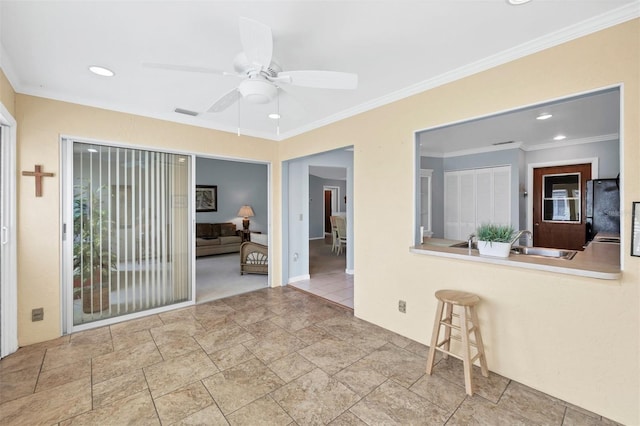 spare room featuring ceiling fan, ornamental molding, and sink