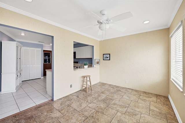 unfurnished room with ceiling fan and ornamental molding