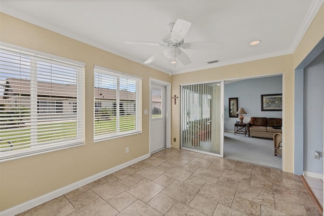 interior space featuring ceiling fan and crown molding